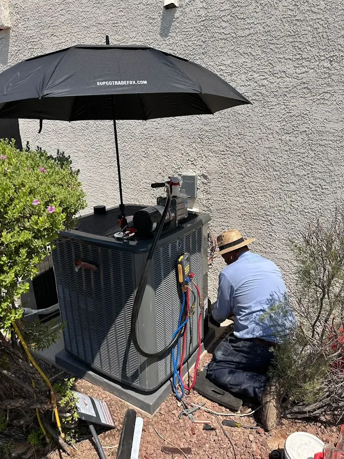 HVAC technician performing outdoor AC maintenance in Palm City